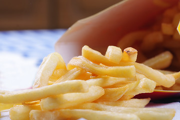 Image showing French fries scattered from pocket
