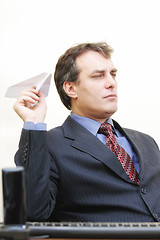 Image showing Serious businessman aiming plane