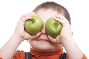 Image showing Boy shutting eyes with apples