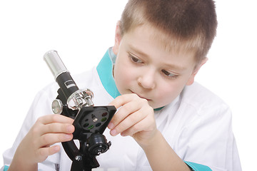 Image showing Kid adjusting microscope