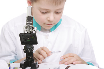 Image showing Boy working with magnifying glass