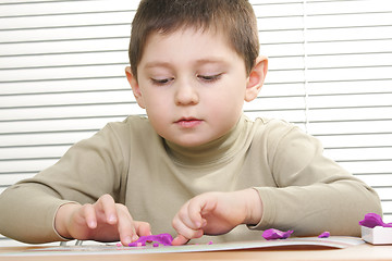 Image showing Kid modelling plasticine sculpture