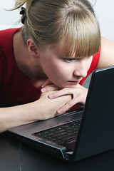 Image showing Businesswoman in red looking to monitor