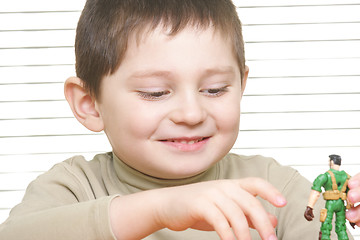 Image showing Smiling boy with toy soldier