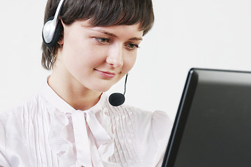 Image showing Businesswoman with headset at computer