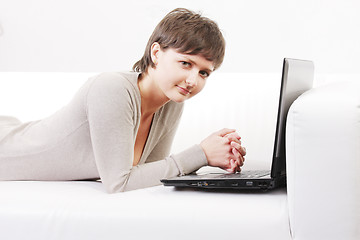 Image showing Woman on sofa with computer