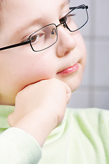 Image showing Thoughtful boy leaning on fist