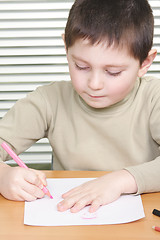 Image showing Kid drawing with pink pencil