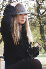 Image showing Woman in black coat and hat