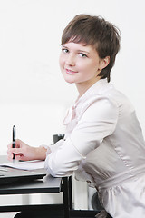 Image showing Pretty businesswoman at desk