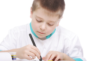 Image showing Boy examining object in lab