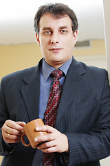 Image showing Confident businessman with cup