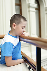 Image showing Boy at banister looking down