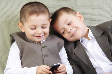 Image showing Brothers with cellphone