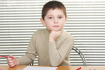 Image showing Serious boy leaning on fist