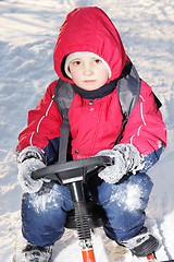 Image showing Serious boy on sledge