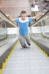 Image showing Boy running up by escalator