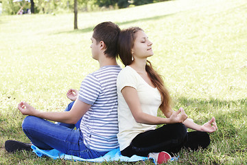 Image showing Young couple relaxing in yoga pose