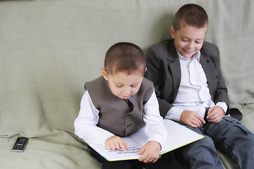Image showing Positive brothers reading book