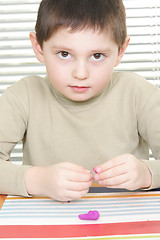 Image showing Little boy with plasticine