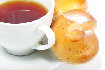 Image showing Tea with bun over white