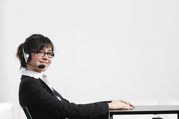 Image showing Businesswoman sitting at desk sideview