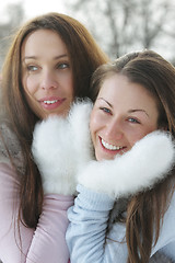 Image showing Two women in white mittens