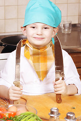 Image showing Smiling cook with two knives