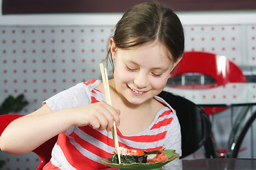 Image showing Girl eating sushi