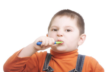 Image showing Boy brushing teeth with effort