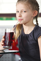 Image showing Little girl drinking juice