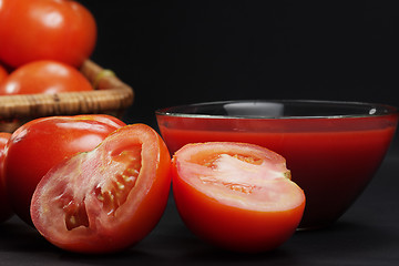 Image showing Sliced tomato in darkness