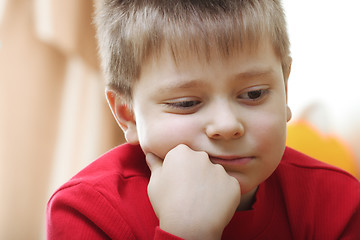Image showing Thoughtful kid in red