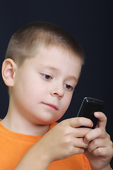 Image showing Kid reading message on cellphone