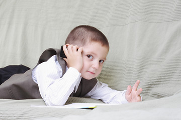 Image showing Little boy with cellphone and book