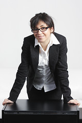 Image showing Confident businesswoman leaning on desk