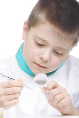 Image showing Boy examining object through magnifier