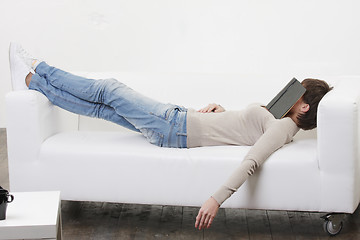 Image showing Afternoon nap with book on face