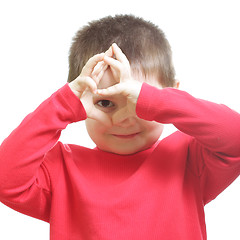 Image showing Little boy looking through finger frame