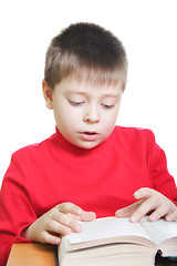 Image showing Boy in red reading book at desk