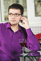Image showing Guy in cafe with cellphone