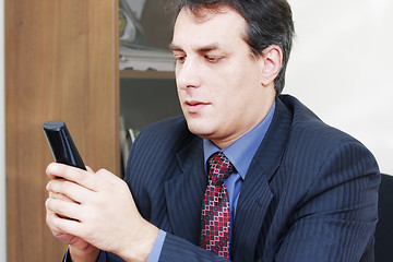 Image showing Businessman holding cordless phone