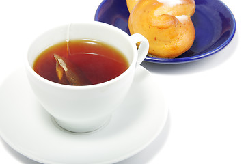 Image showing Tea and bun in blue saucer