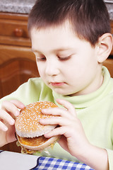 Image showing Kid looking at hamburger