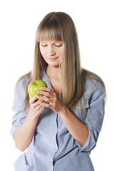 Image showing Blonde looking at apple