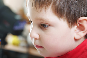 Image showing Pensive boy in red