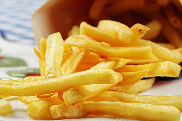 Image showing French fries scattered on table
