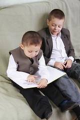 Image showing Brothers reading book