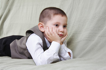 Image showing Little boy laying on sofa