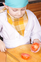 Image showing Little cook cut tomato